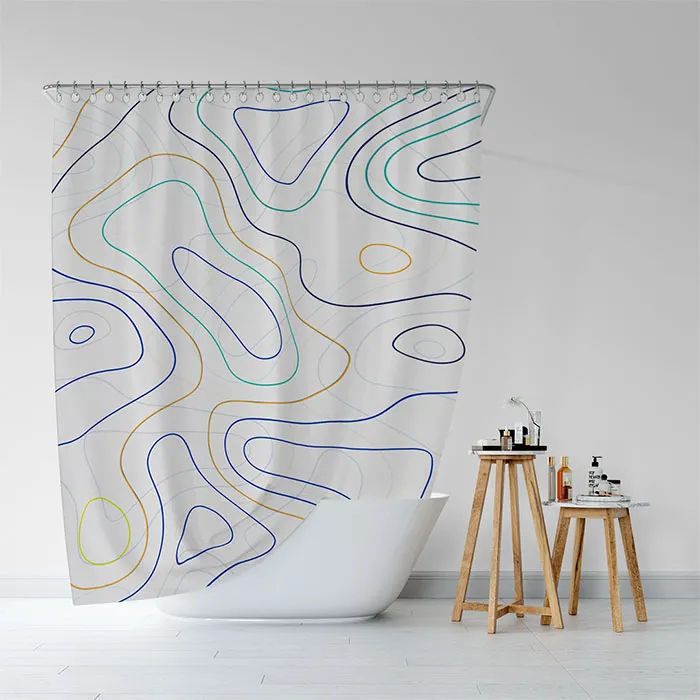 white shower curtain with blue, green, and yellow lines forming loose shapes in a loose pattern, there's a two wooden tables next to the bathtub 