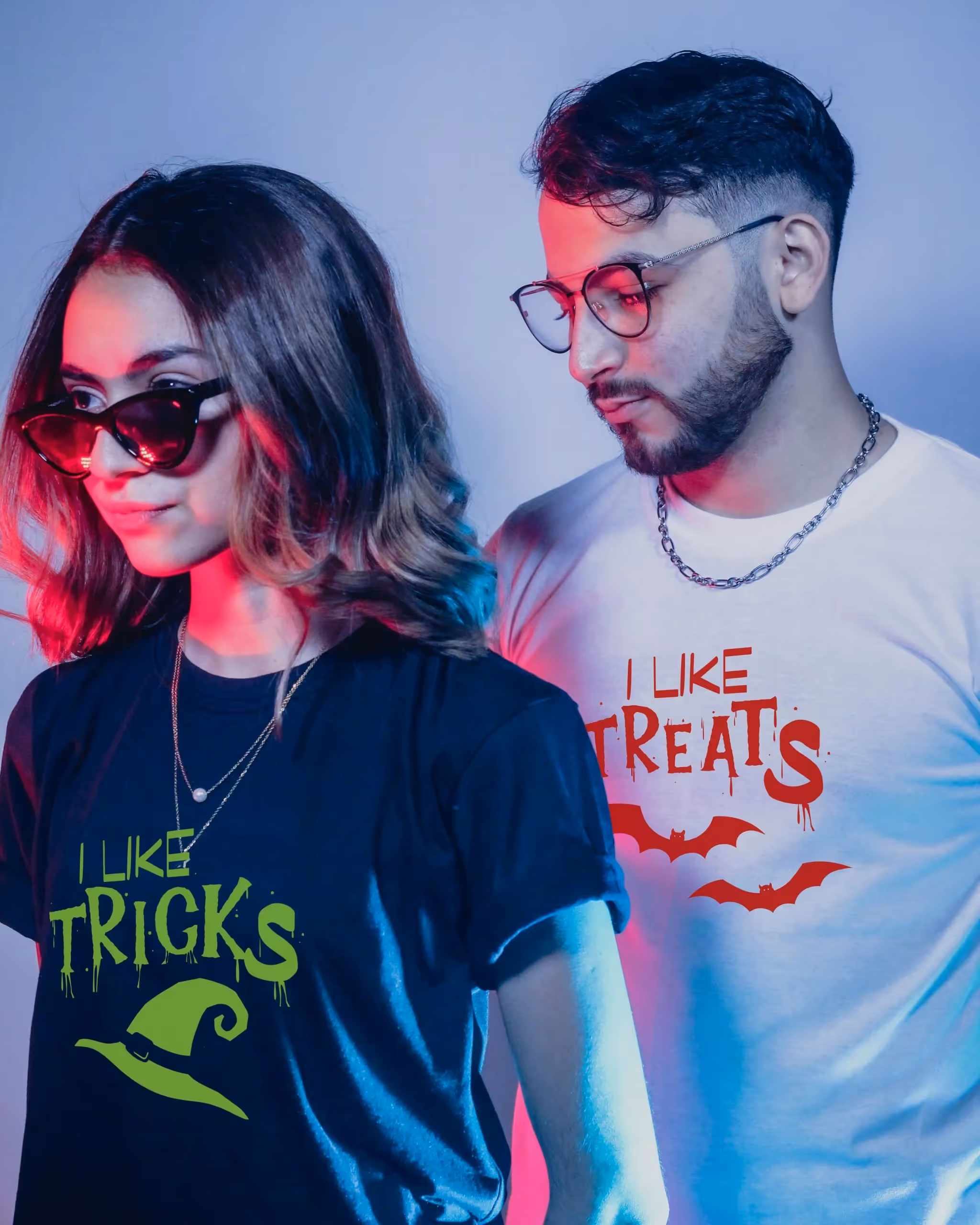 Couple wearing shirts that say "I Like Tricks" and "I Like Treats"