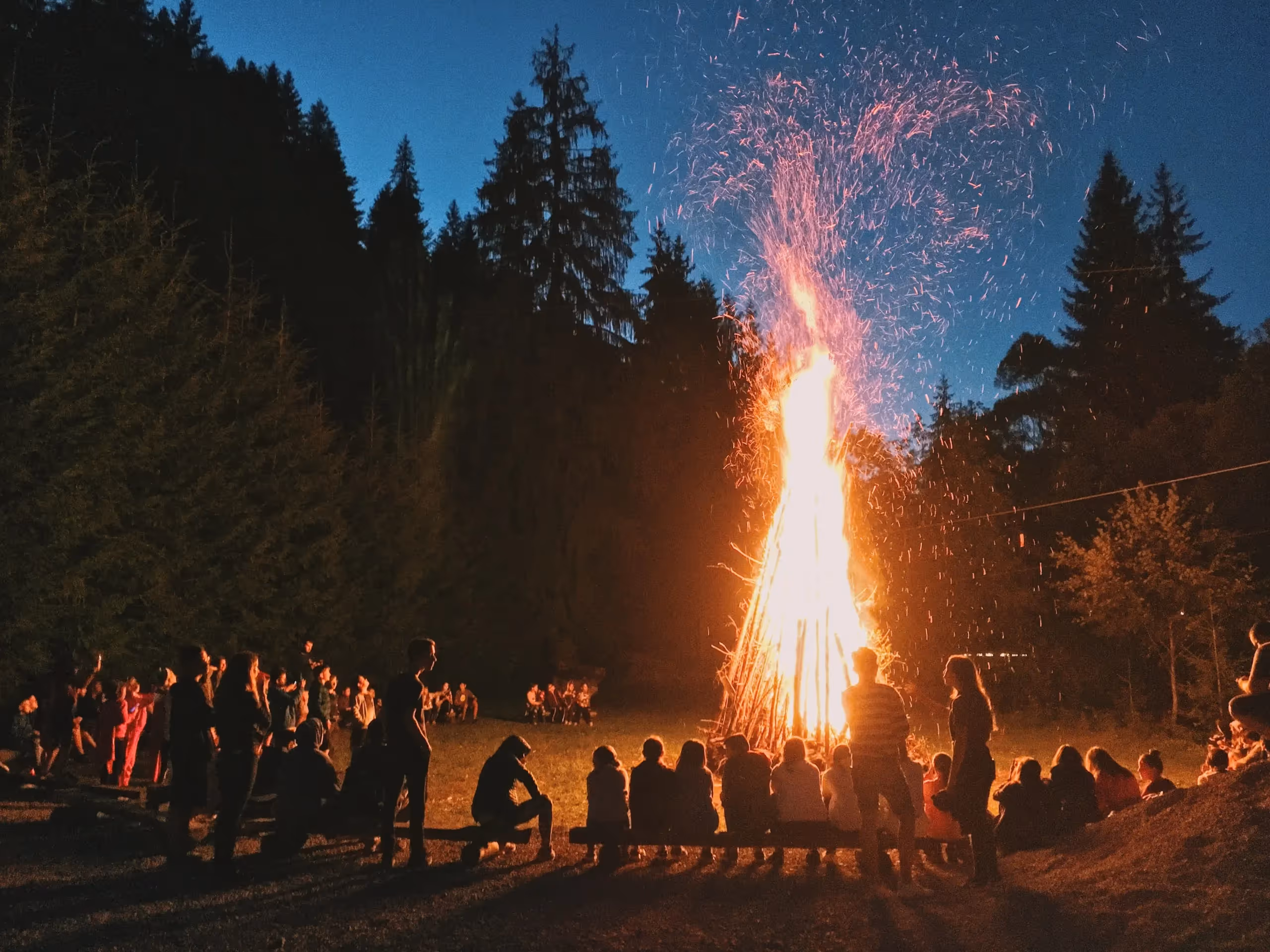 People gathered around a large bonfire