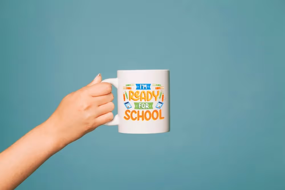 Hand holding a white ceramic mug with colorful “I’m Ready for School” design — perfect back-to-school gift for students or teachers.