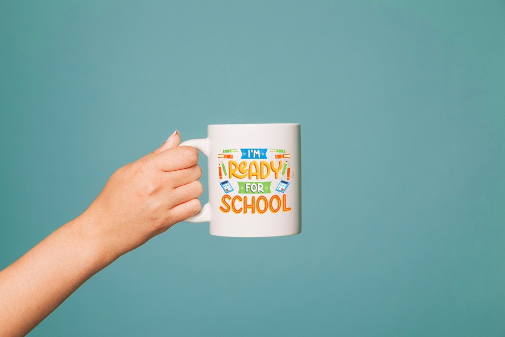 Hand holding a white ceramic mug with colorful “I’m Ready for School” design — perfect back-to-school gift for students or teachers.