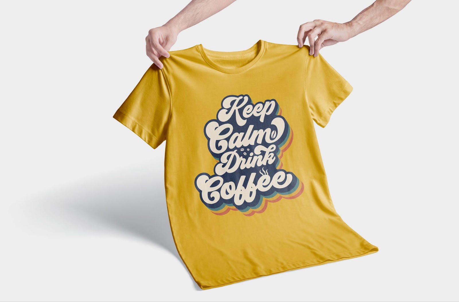 Yellow T-shirt with retro typography ‘Keep Calm Drink Coffee’ design – custom coffee-themed apparel for print-on-demand sellers