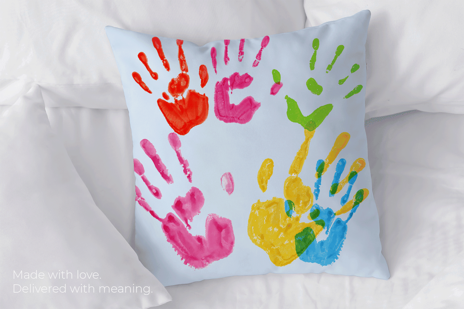 White pillow with colorful painted handprints – personalized Grandparents Day gift idea made with love
