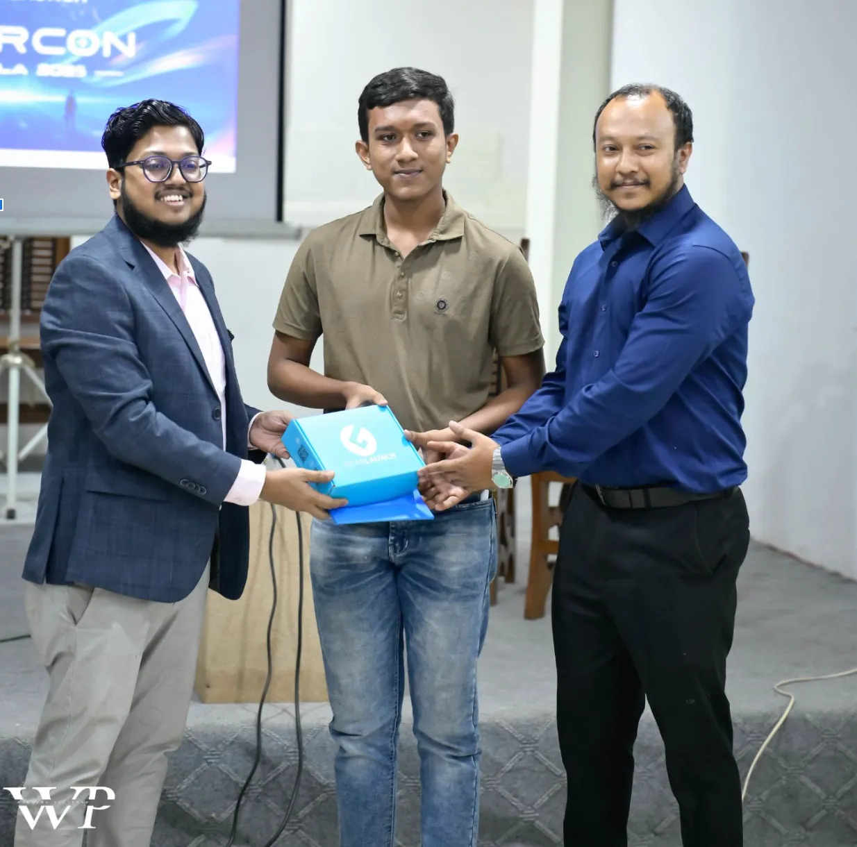 GearCon Comilla 2025 award ceremony — entrepreneur receiving a GearLaunch prize on stage in Comilla.