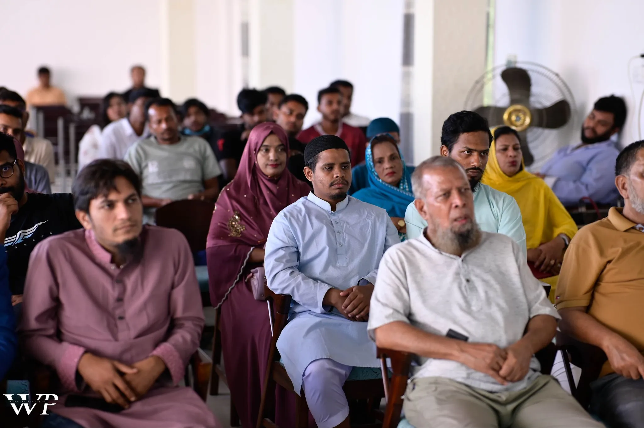 Audience at GearCon Comilla 2025 listening to Print-on-Demand business sessions, showcasing community diversity in Bangladesh.
