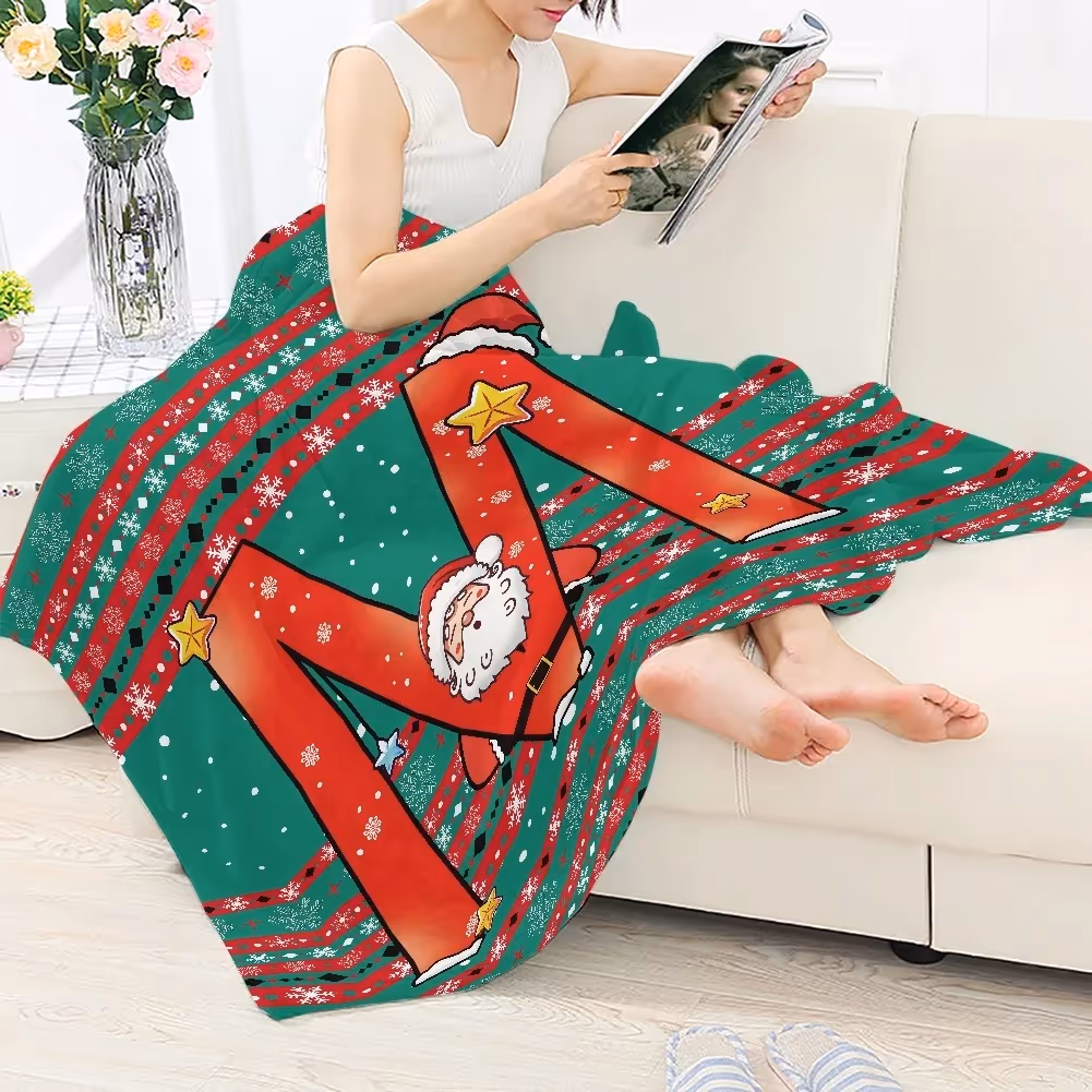 Woman reading on sofa with a green and red personalized Christmas blanket featuring Santa and festive patterns