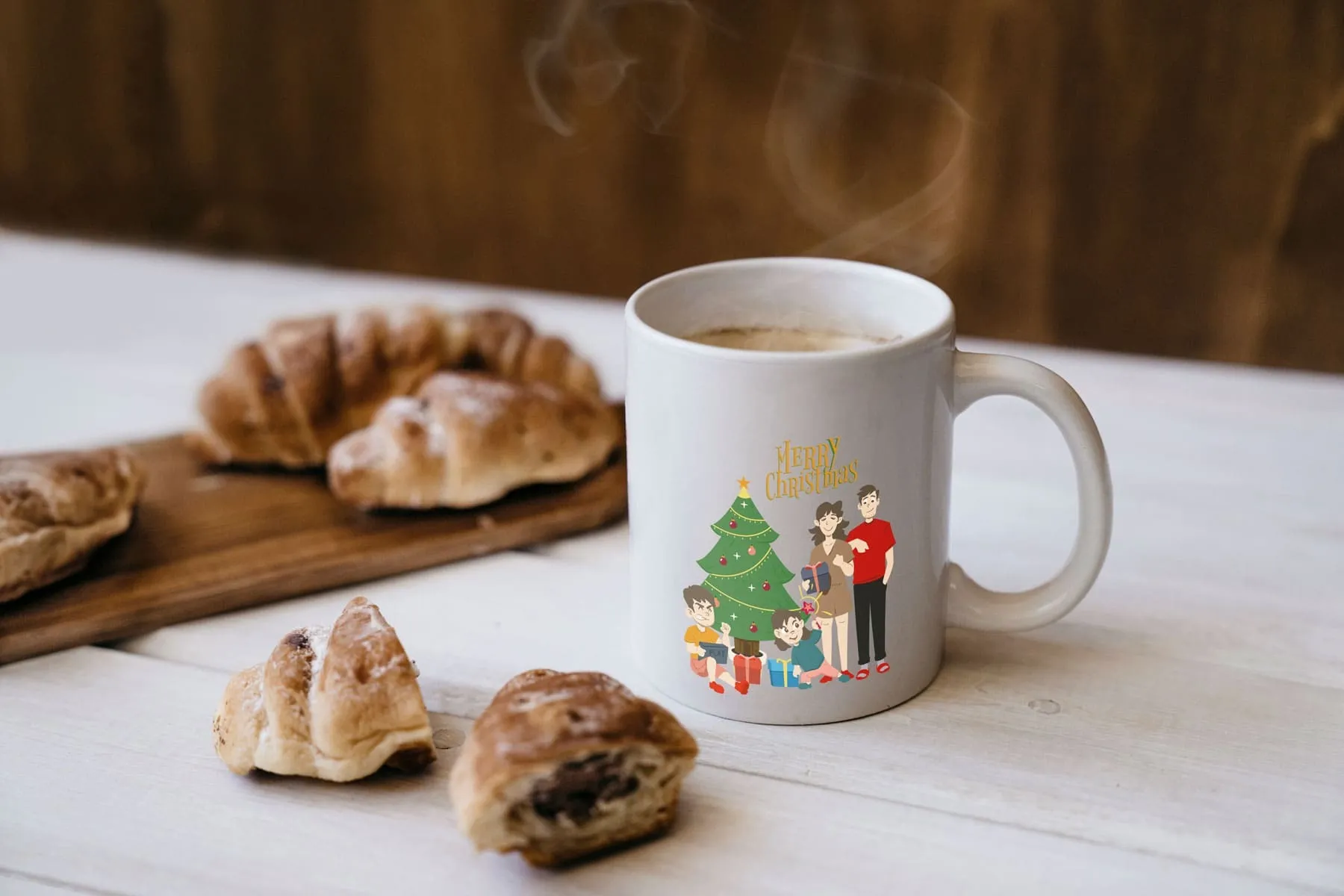White ceramic mug with a personalized Christmas family design beside croissants — ideal for showcasing customizable holiday gift products.