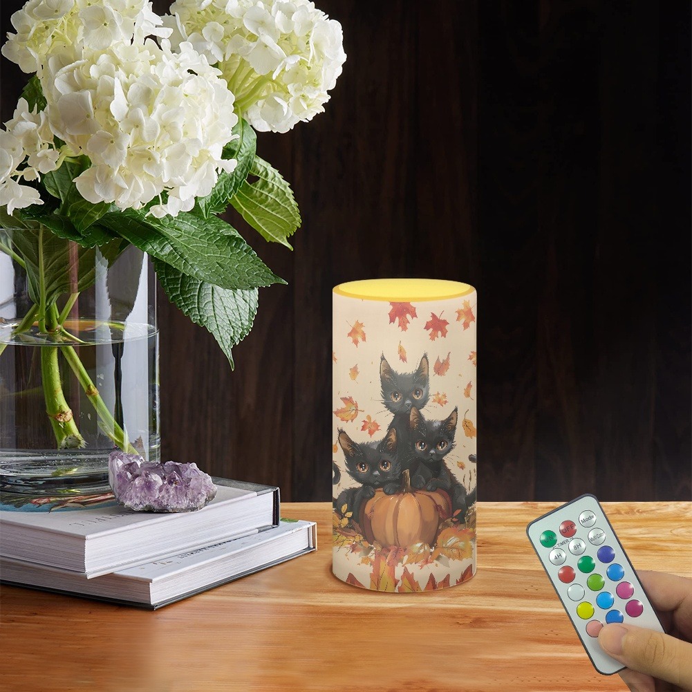 Remote control LED candle with autumn leaf print for holiday home decor.