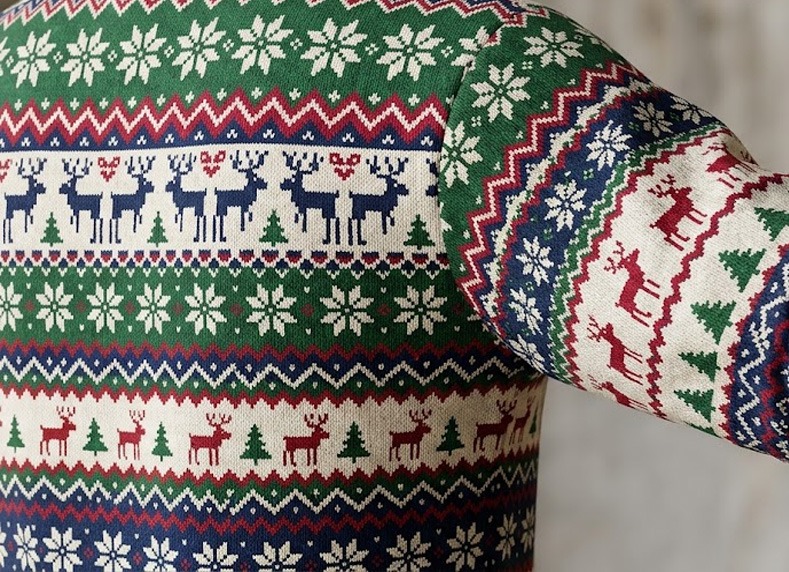 Detailed view of seamless fair isle sleeve design on an all-over-print Christmas sweater