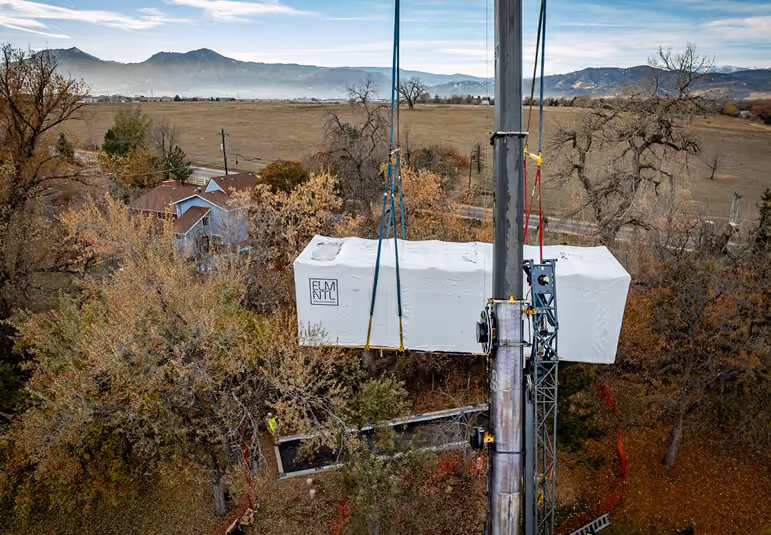 An image showcasing the delivery process of ELMNTL prefab modular cabins