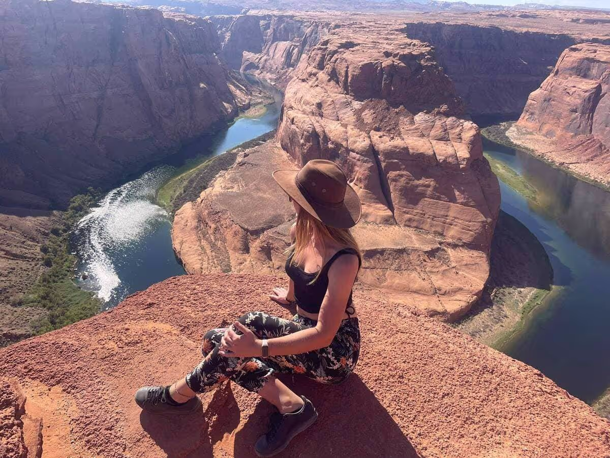 A woman sitting down at the Grand Canyon