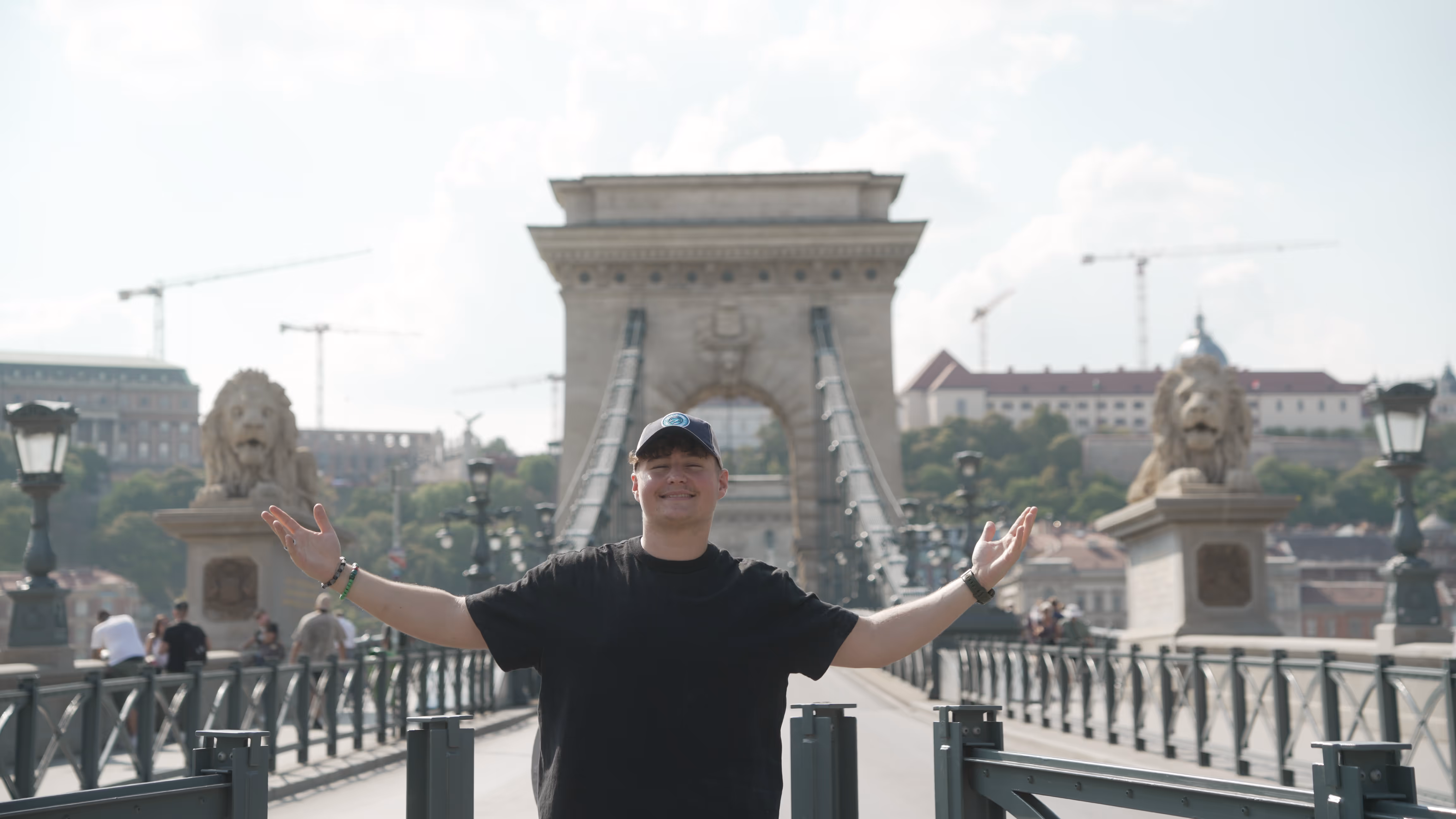 A man standing by a bridge in Budapest