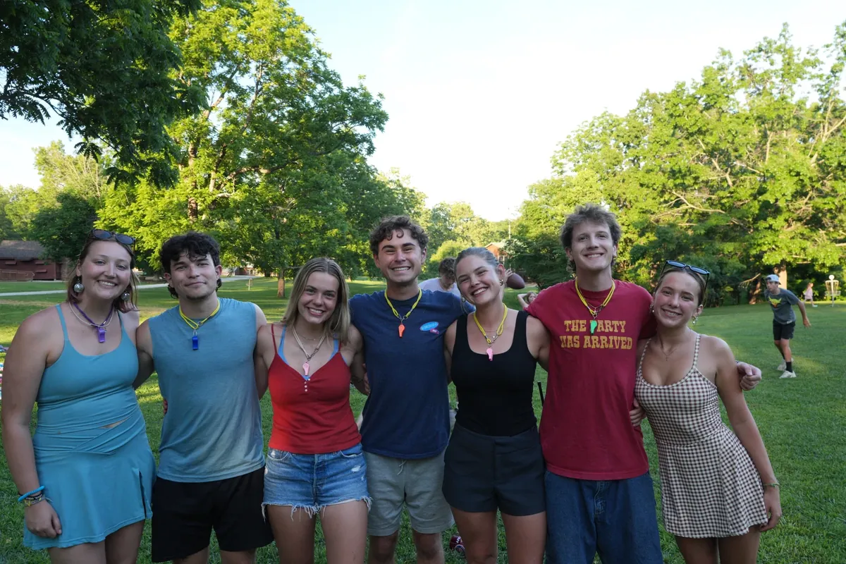 A group of Camp Leaders counselors smiling on a camp field