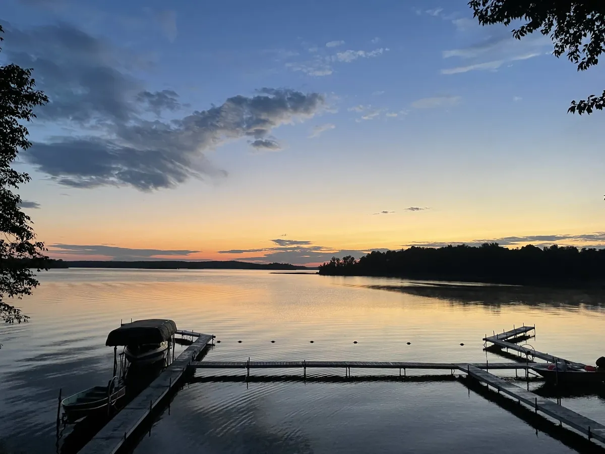 Sunset over a camp lake with docks and boats