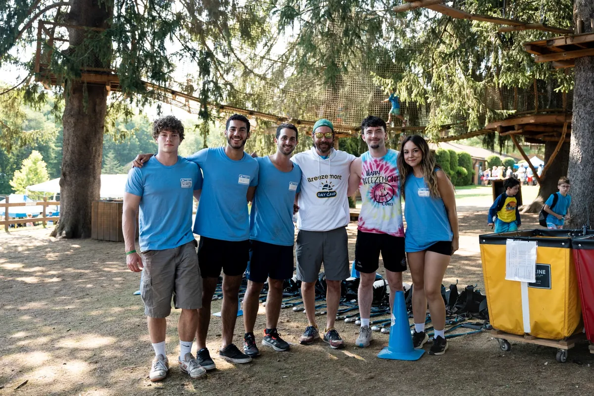 A team of counselors at a high ropes course