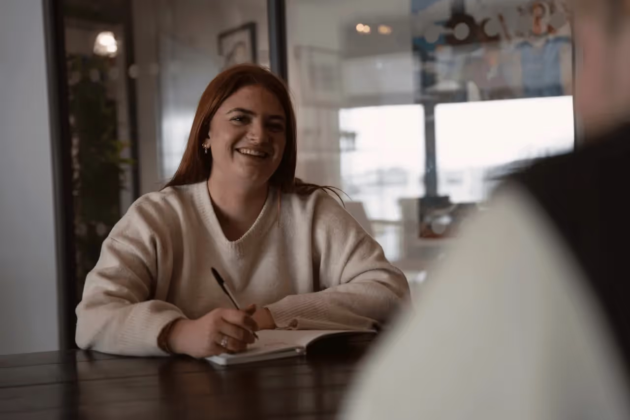 Woman engaged in conversation with a staff member