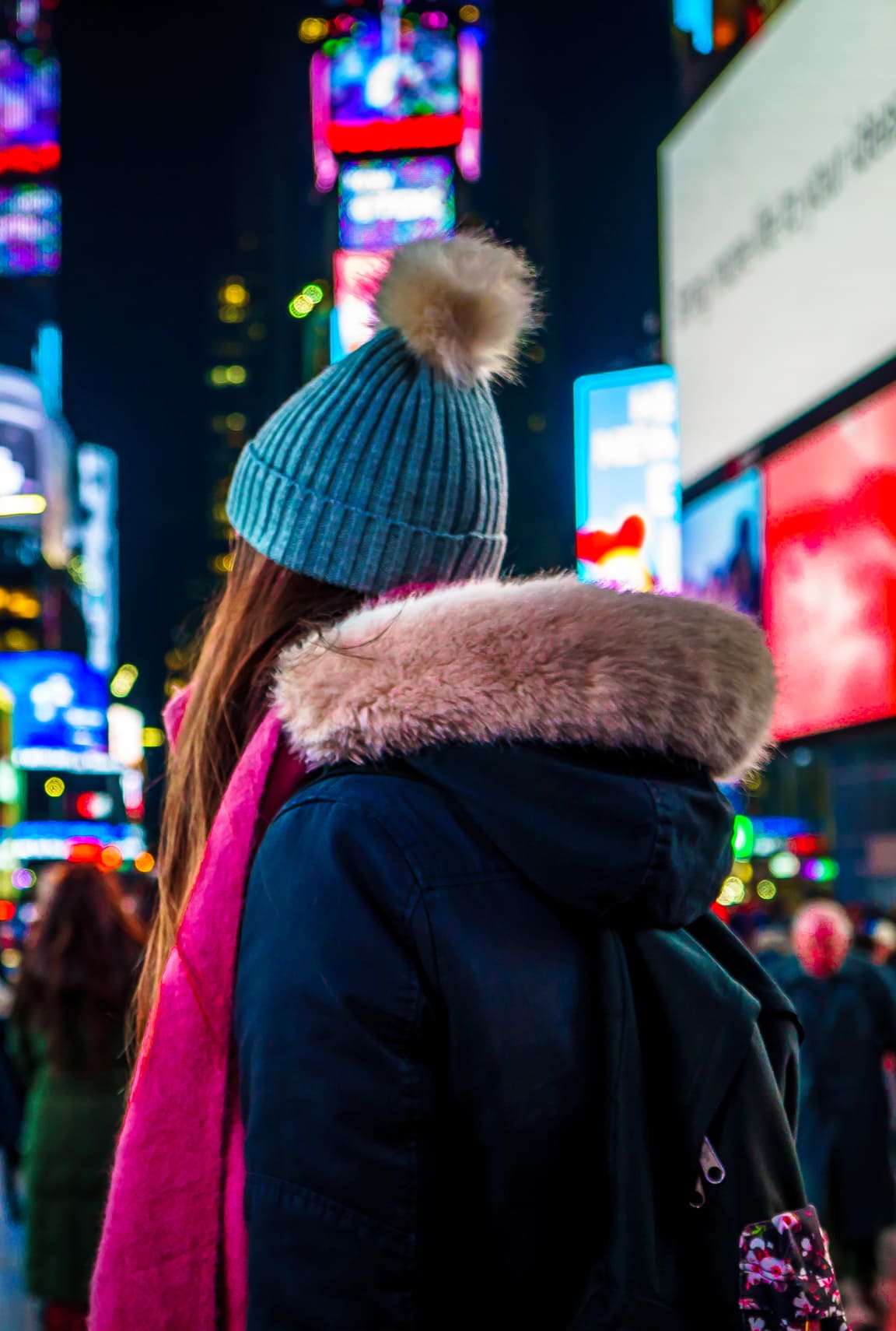 A woman in Times Square at night