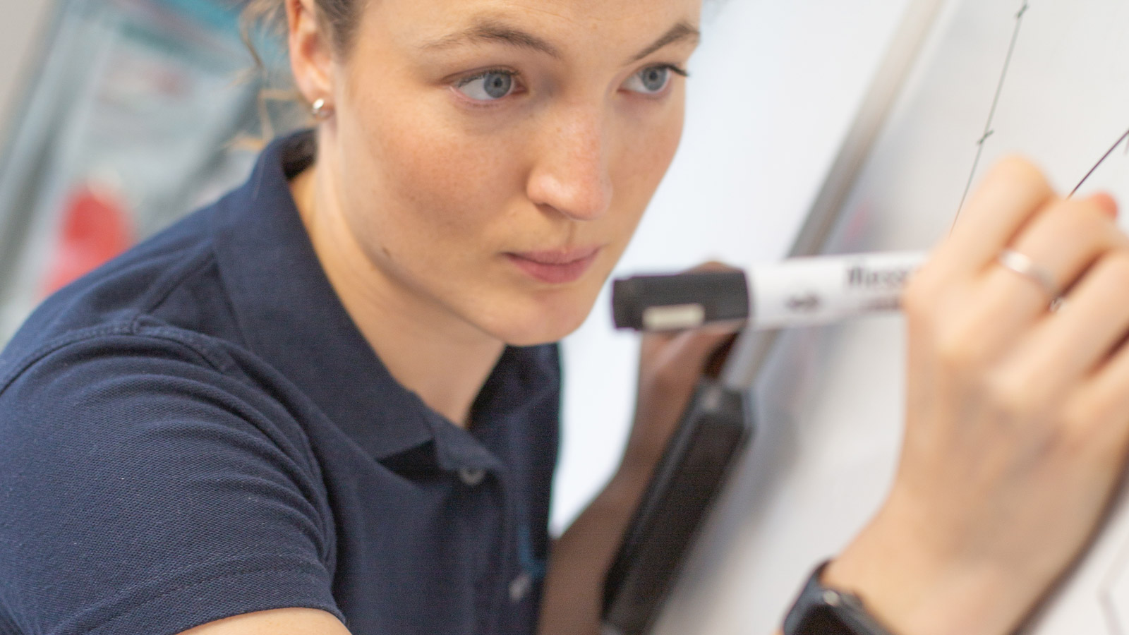 Physiotherapist mapping out a personalised shoulder rehabilitation plan on a whiteboard at Dan Rix Physiotherapy