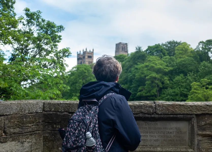 Pilgrim staring towards Grey Towers on Prebends Bridge