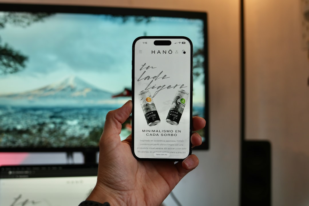 Hand holding smartphone displaying website with drinks. for How to Design Mobile-First Forms That Actually Convert: A Guide for Small Business Websites