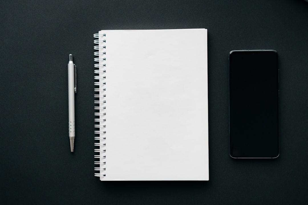 A notebook and a pen for "5 Minimalist Web Design Trends Small Businesses Are Using to Boost Conversions"