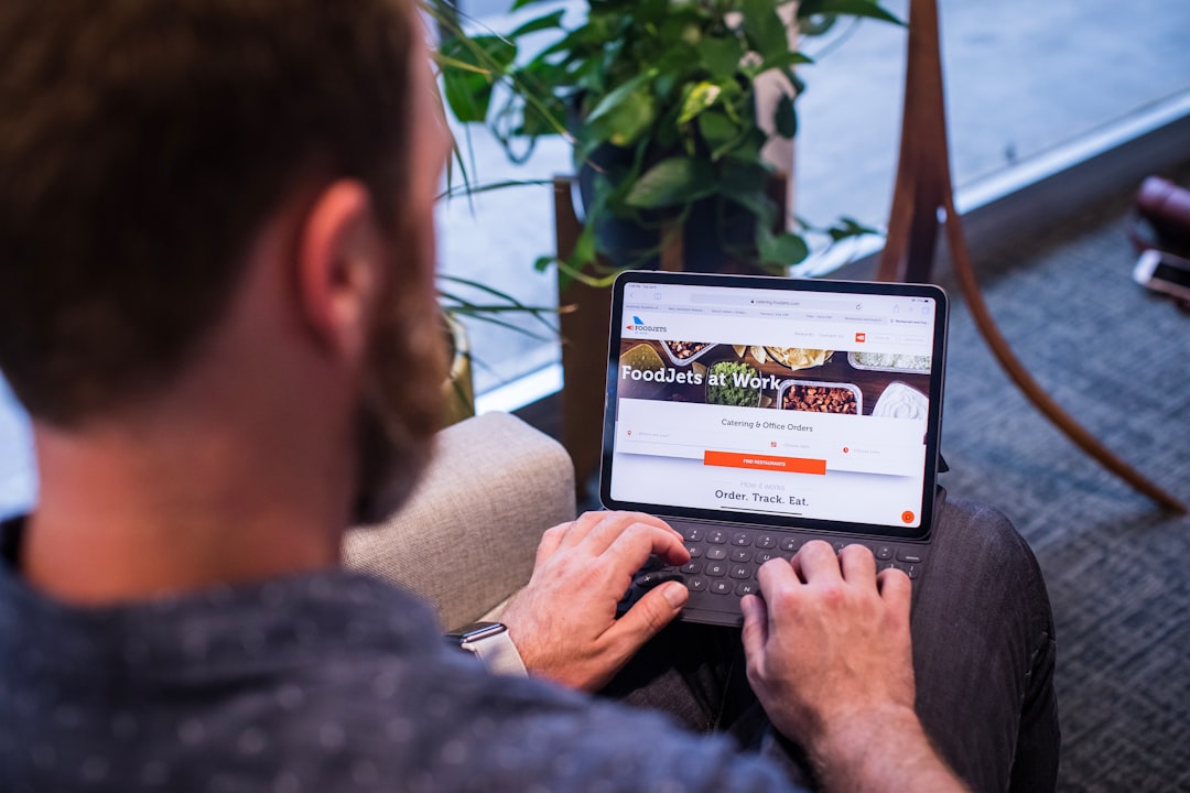 Person using laptop for "10 Free and Low-Cost Social Media Management Tools That Actually Save Small Business Owners Time"