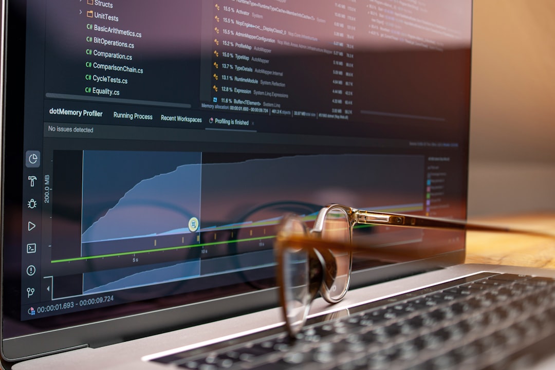 Laptop screen displaying code and graphs with glasses on keyboard for How to Set Up Custom Events in Google Analytics 4 to Track What Actually Matters for Your Business