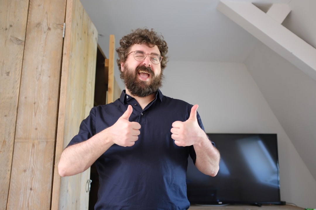 A man with a beard giving a thumbs up for "The Complete Guide to Figma for Small Business Owners: Free Features That Replace Expensive Design Software"