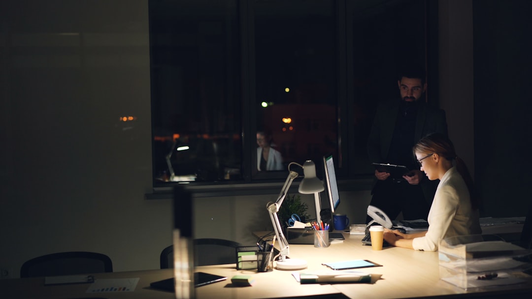 People working late in a dimly lit office. for How We Organize Client Projects to Meet Tight Deadlines: A Studio Workflow Breakdown