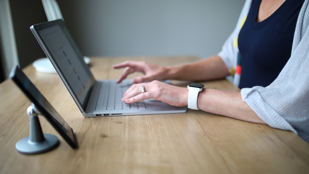 Person in white and blue shirt using macbook pro for How to Conduct an Accessibility Audit of Your Website Without Hiring an Expert