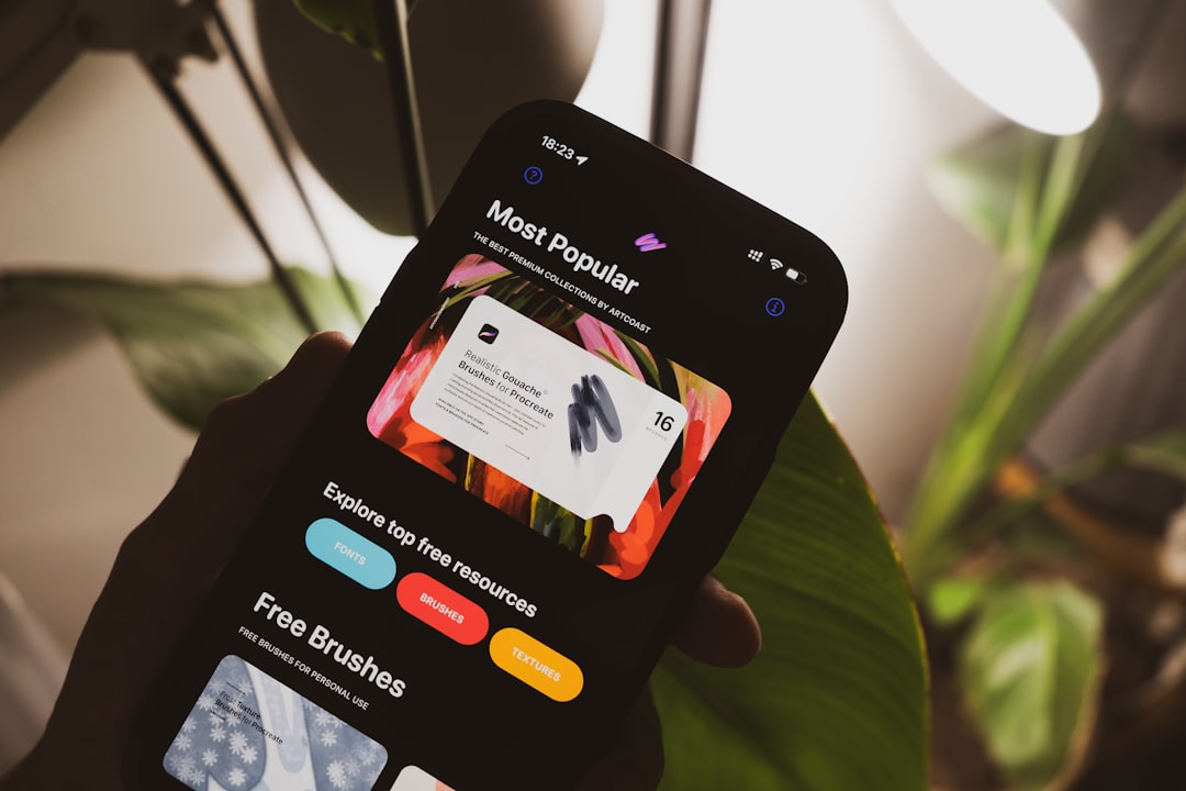 A person holding a cell phone with a website on the screen for How to Create a Mobile-Friendly Website Without Coding: A Step-by-Step Guide for Small Business Owners