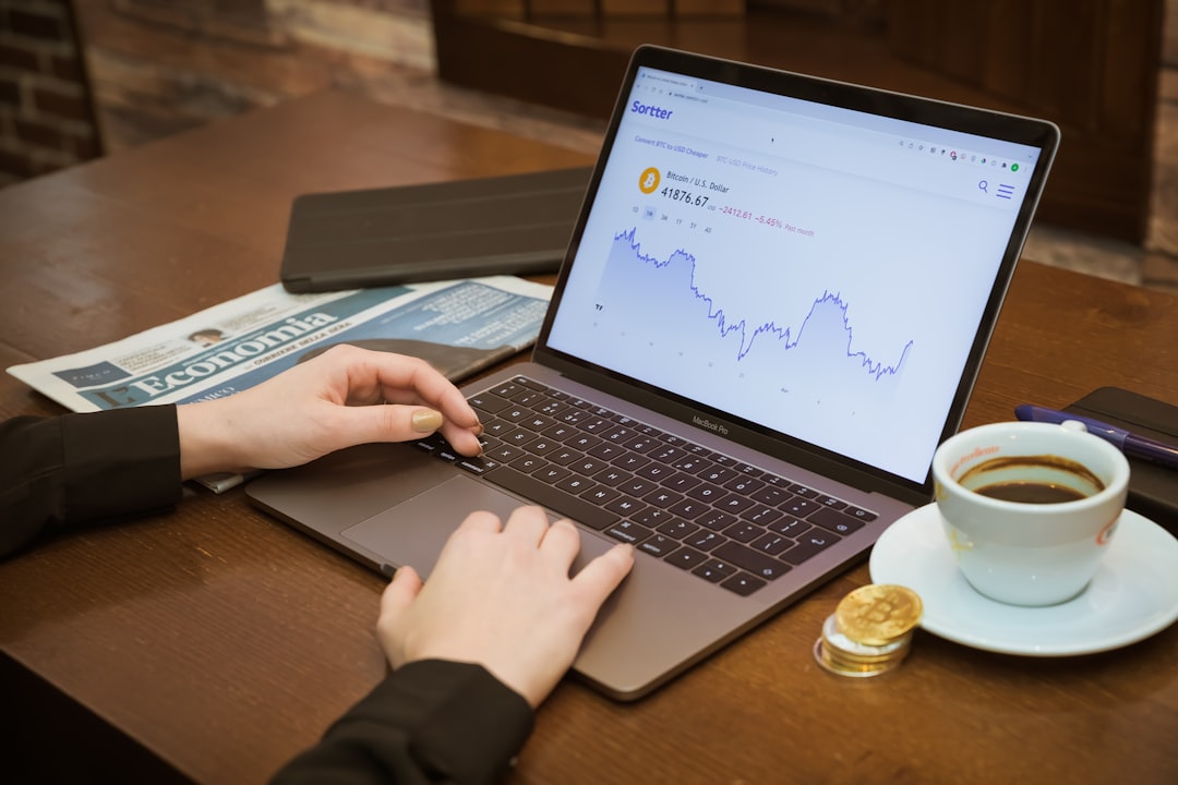 A person using a laptop computer on a table for How to Set Up Custom Conversion Goals in Google Analytics to Track What Actually Matters for Your Business