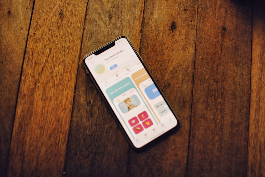 A smartphone displays a colorful app on wood. for How a Local Bakery Increased Online Orders by 40% with a Mobile-First Website Redesign