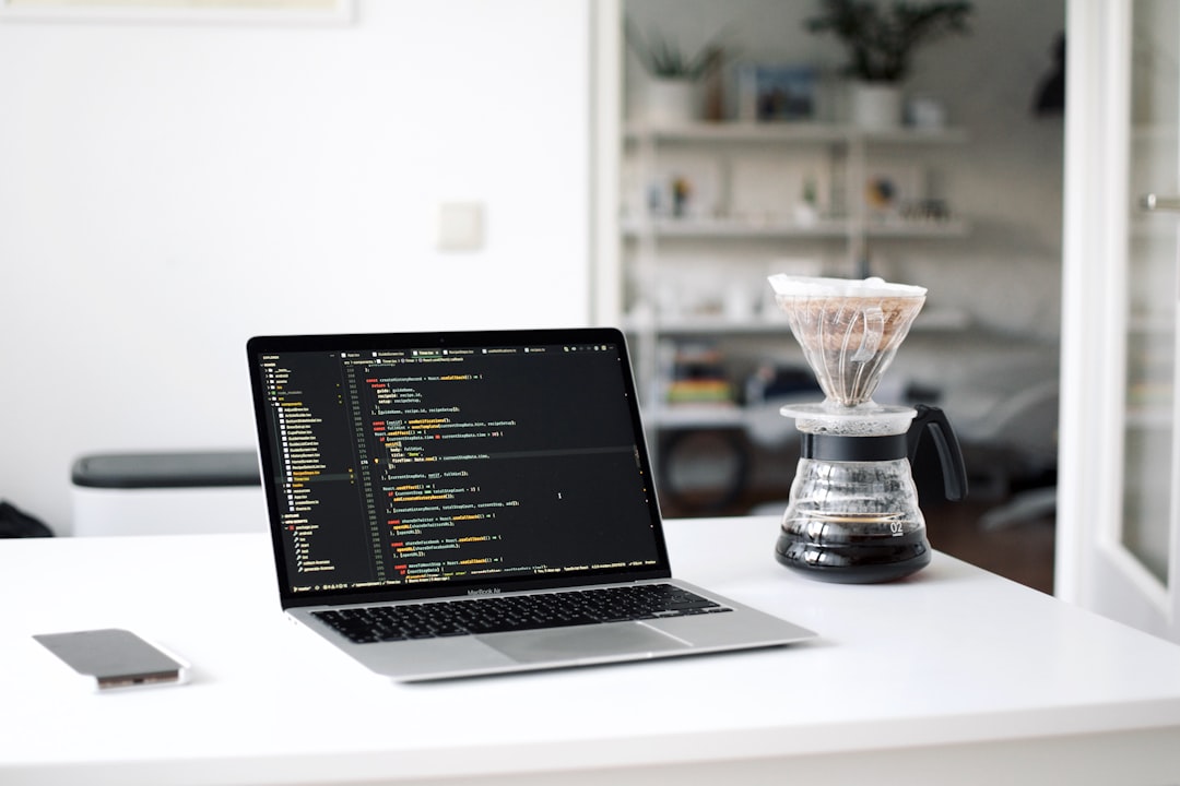 Black laptop computer beside clear glass cup for How We Redesigned Our Client Onboarding Process to Cut Project Setup Time in Half