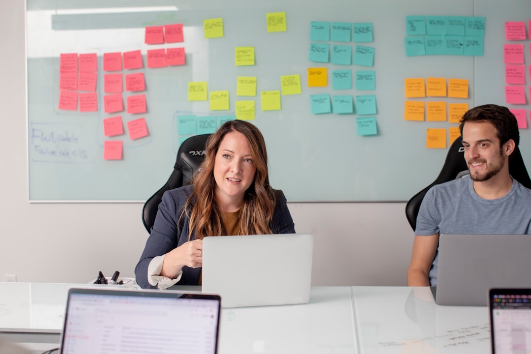 Woman in black shirt sitting on chair in front of laptop computer for How We Redesigned Our Client Onboarding Process to Cut Project Setup Time in Half