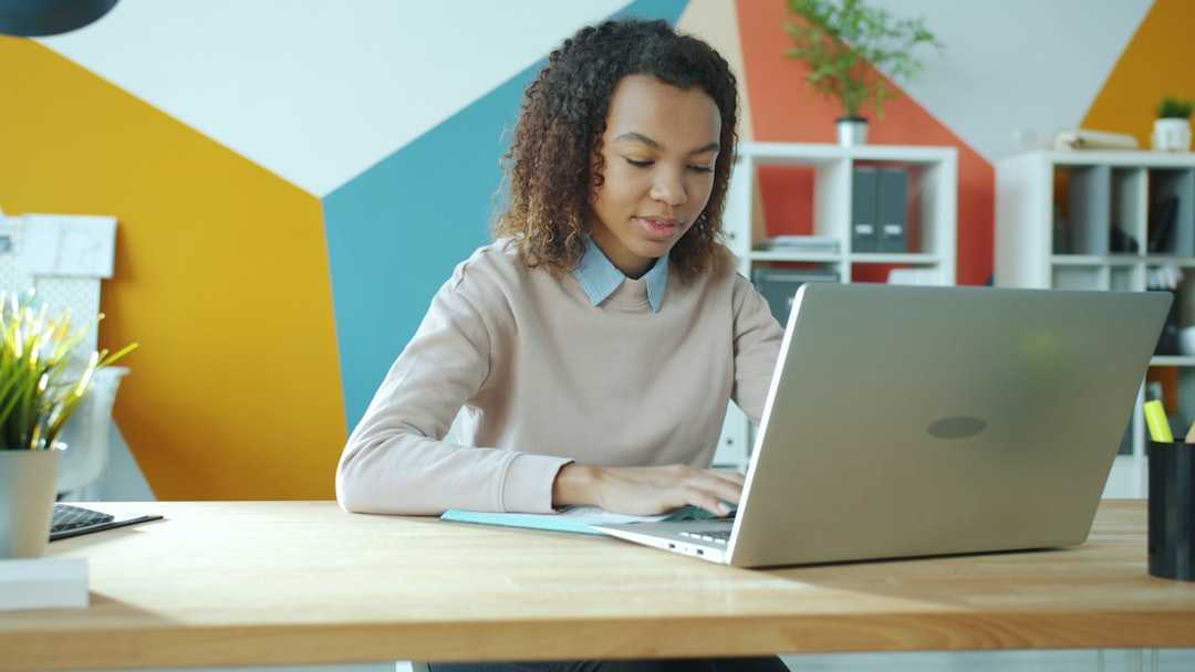 Woman typing on a laptop at a desk. for How to Plan a Website Redesign Without Disrupting Your Business: A Step-by-Step Guide for Small Business Owners