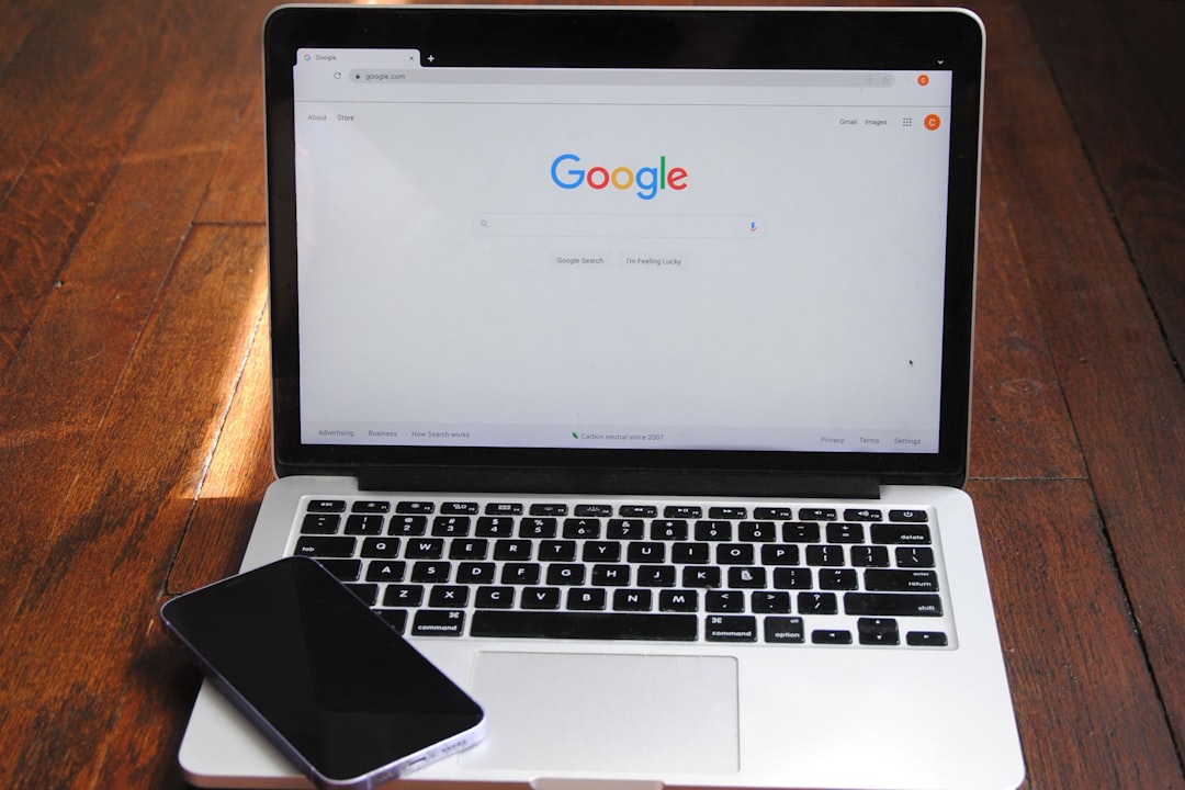A laptop with a cell phone for How to Structure Your Google Ads Budget to Maximize ROI on a Limited Marketing Budget