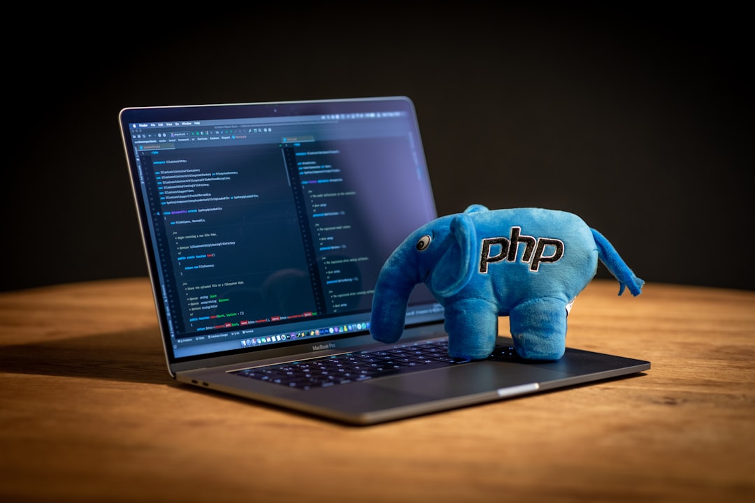Blue elephant plush toy on black laptop computer for How to Choose Between React, Vue, and Angular for Your Small Business Website