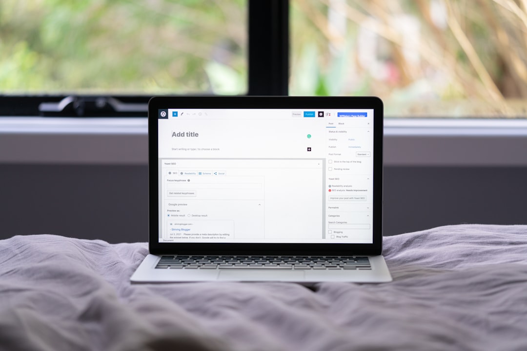 Macbook pro on white bed for How to Find Low-Competition Keywords Your Small Business Can Actually Rank For