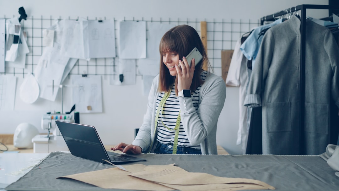 Fashion designer works on laptop while talking on phone. for "The Essential Guide to SSL Certificates: Why Your Small Business Website Needs HTTPS in 2024"