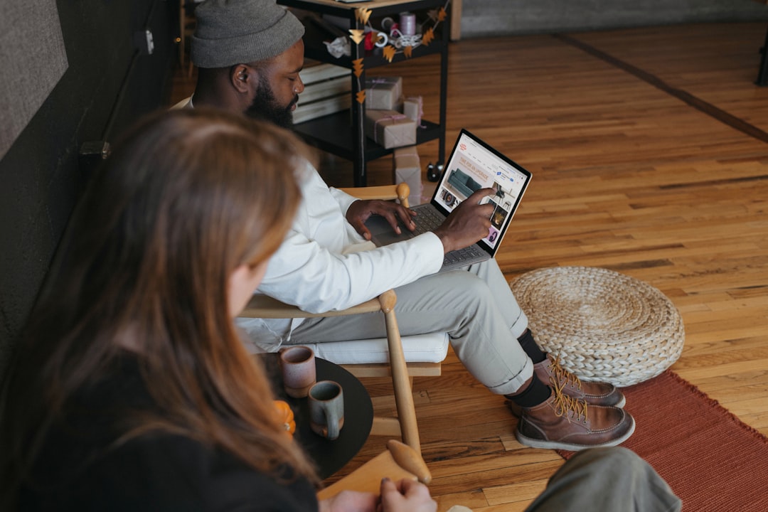 Two people in an office, one person on their Surface laptop for How to Segment Your Email List for Better Open Rates and Customer Engagement