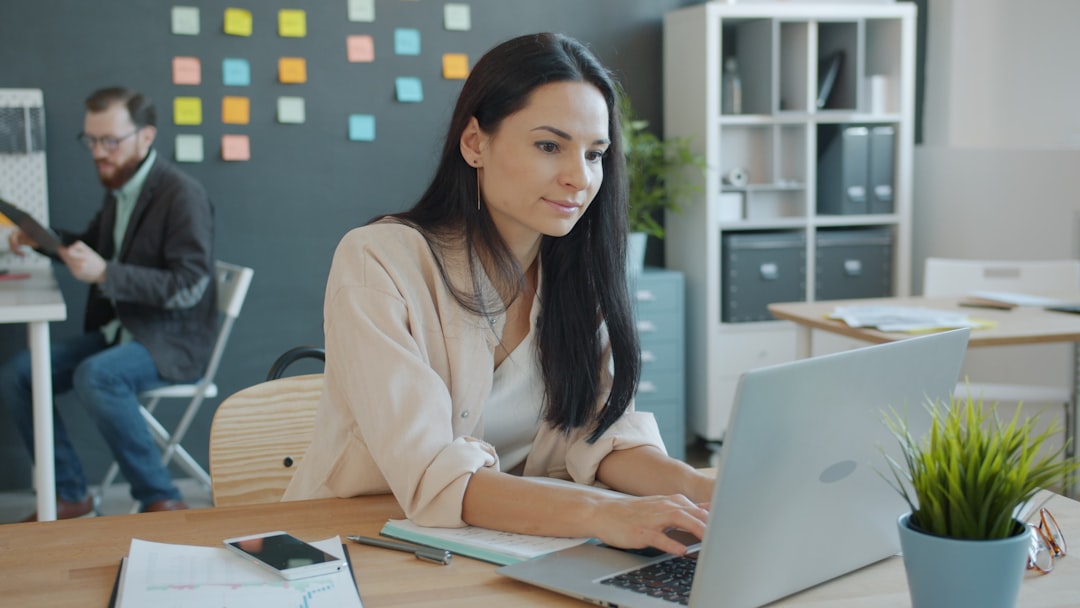 Woman working on laptop in a modern office for "How to Make Your Website ADA Compliant: A Step-by-Step Guide for Small Business Owners"