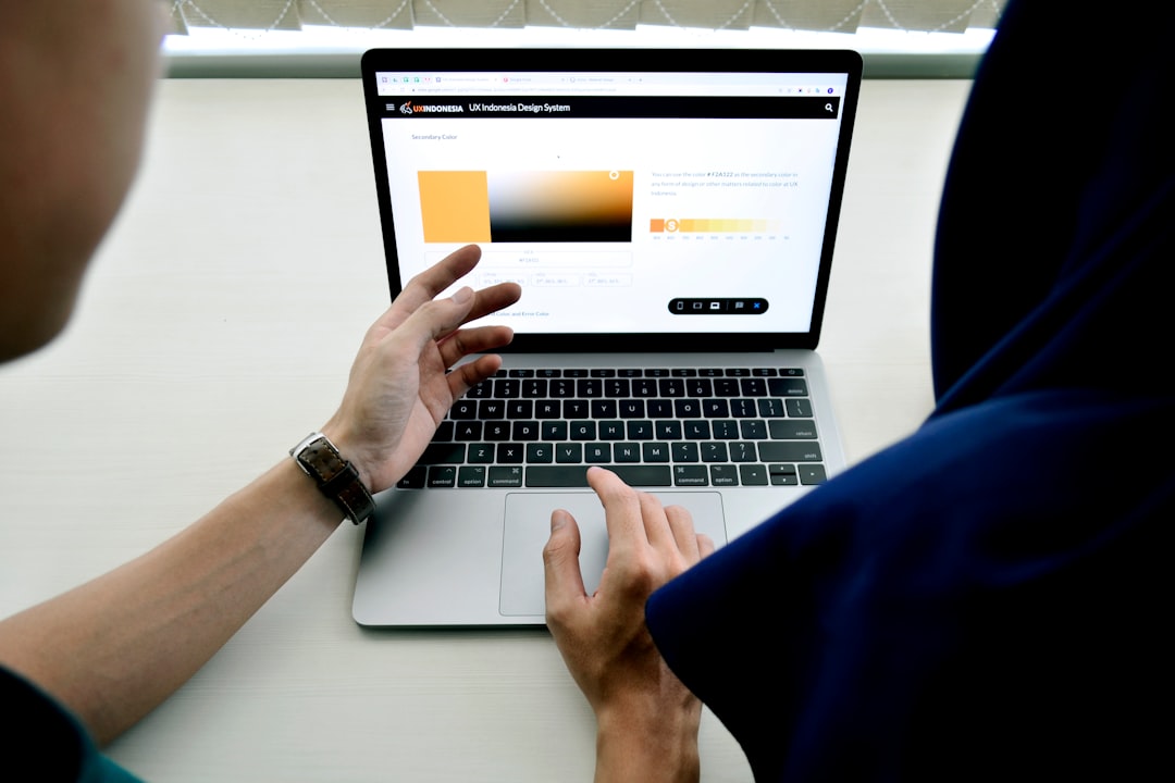 Person using macbook pro on white table for How to Modernize Your Website Without Starting from Scratch: A Phased Makeover Strategy for Small Businesses