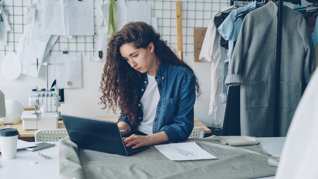 Fashion designer working on a laptop in her studio. for How to Find Long-Tail Keywords Your Competitors Are Missing: A Practical Guide for Small Businesses
