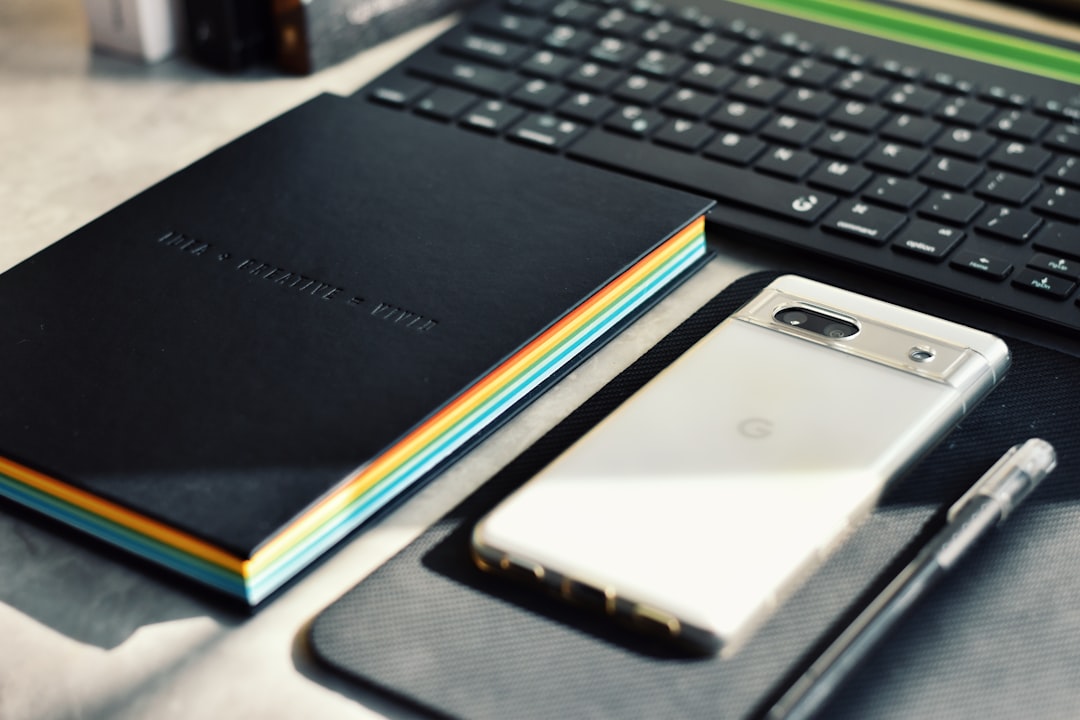A notebook, pen, and cell phone on a table for How to Optimize Your Google Business Profile for Local Search Rankings