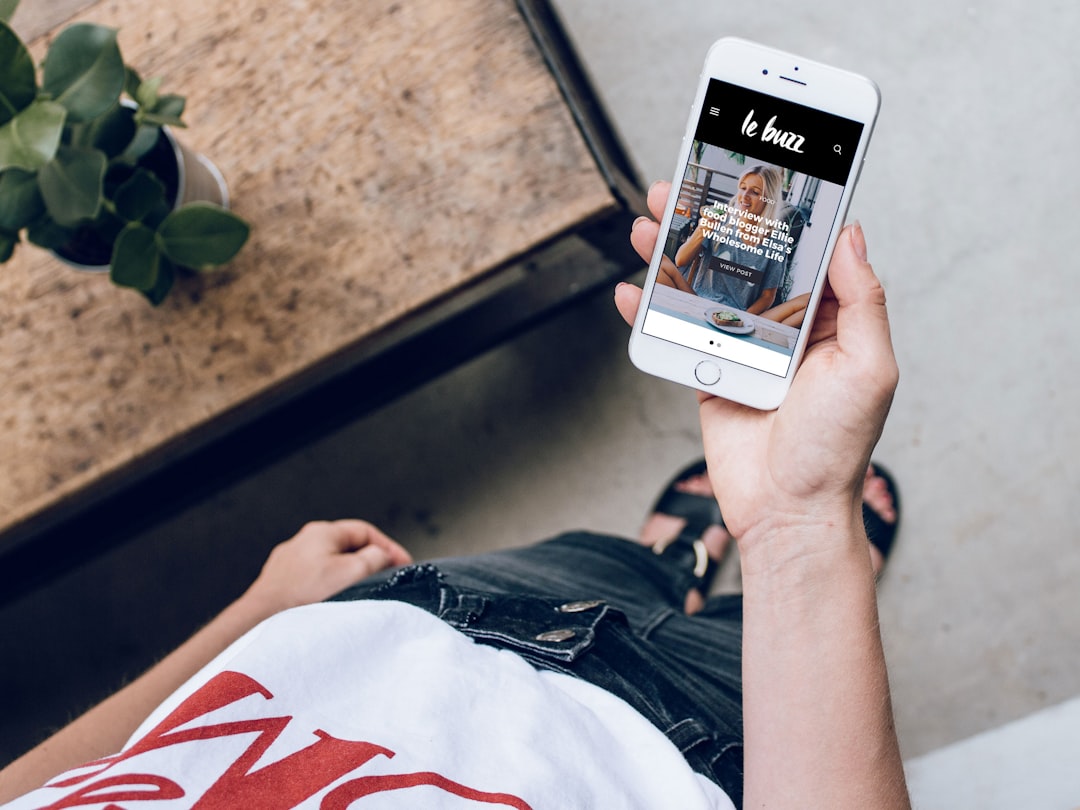 Person holding silver iPhone 6 near green leaf plant for "5 Navigation Mistakes That Kill Small Business Website Conversions (And How to Fix Them)"