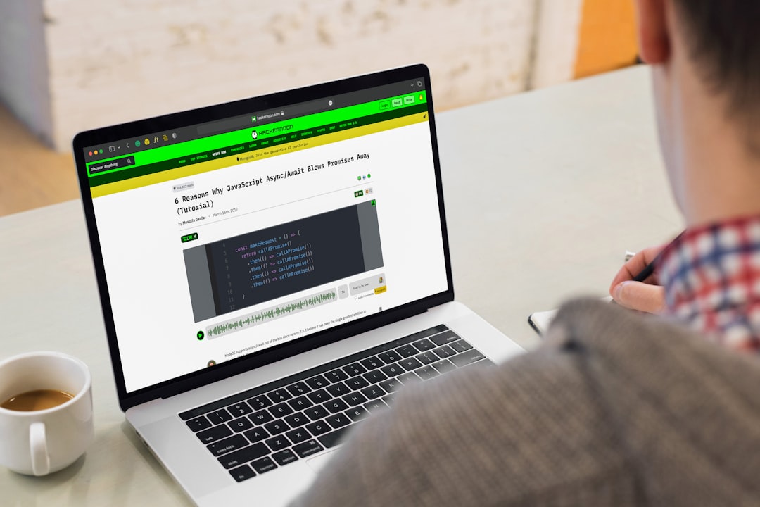 A man sitting in front of a laptop computer for "How to Choose Between React, Vue, and Angular for Your Small Business Website"