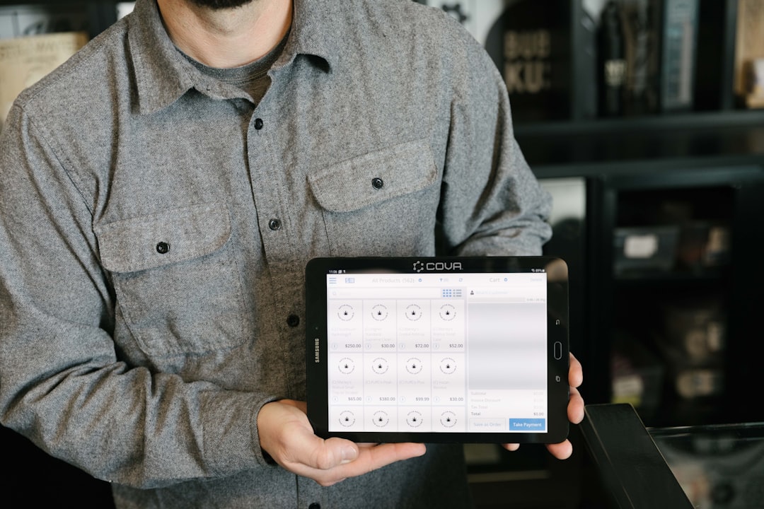 A man holding a tablet in his hands for How Progressive Web Apps Can Help Small Businesses Compete Without Building Native Mobile Apps