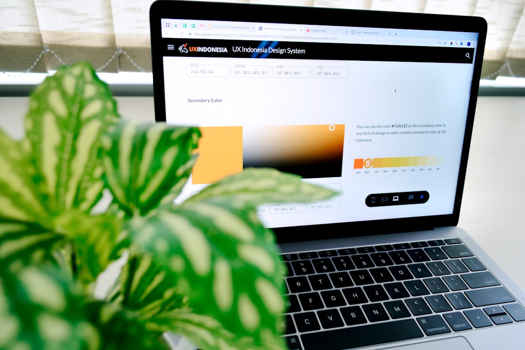 Silver macbook pro turned on displaying green leaves for How to Audit Your Website's Color Contrast for Better Accessibility and Customer Reach