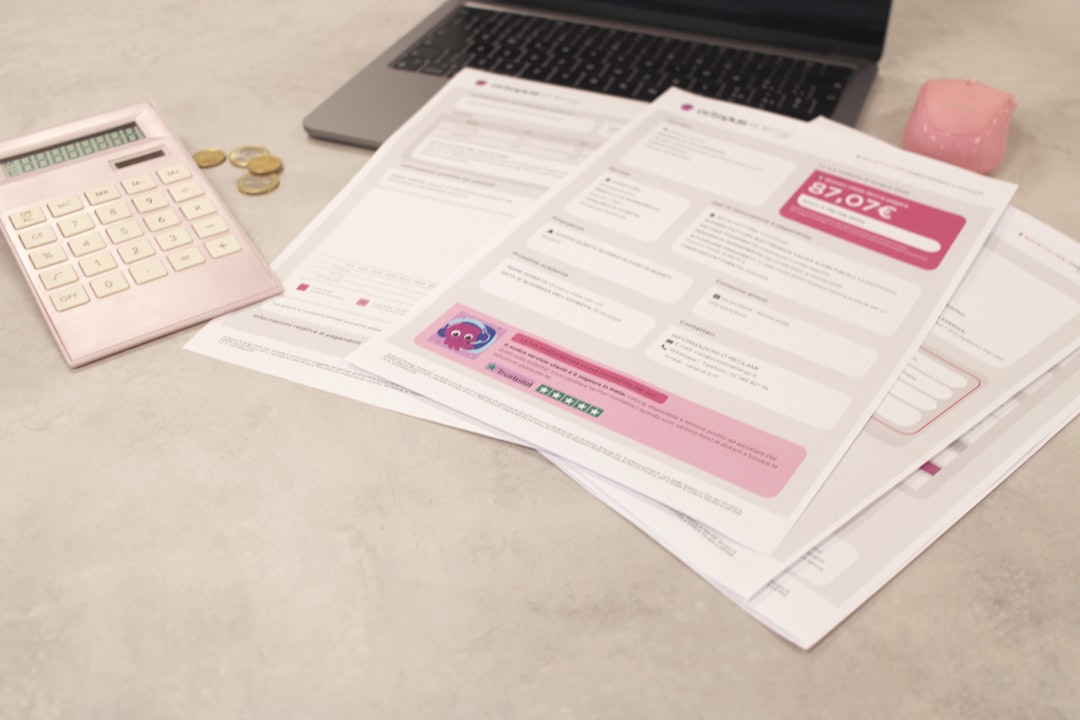 Bills and calculator sit on a desk. for "5 Critical Elements to Audit Before Starting Your Website Redesign"